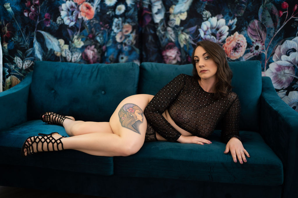 woman in black sheer lingerie laying on a blue couch in Boston
